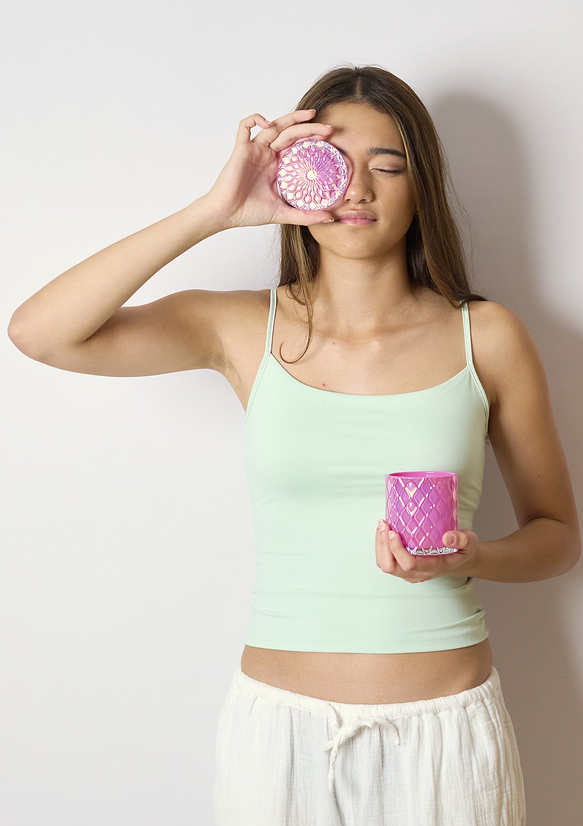 Model holding the AMARIS Strawberry Luxe candle vessel