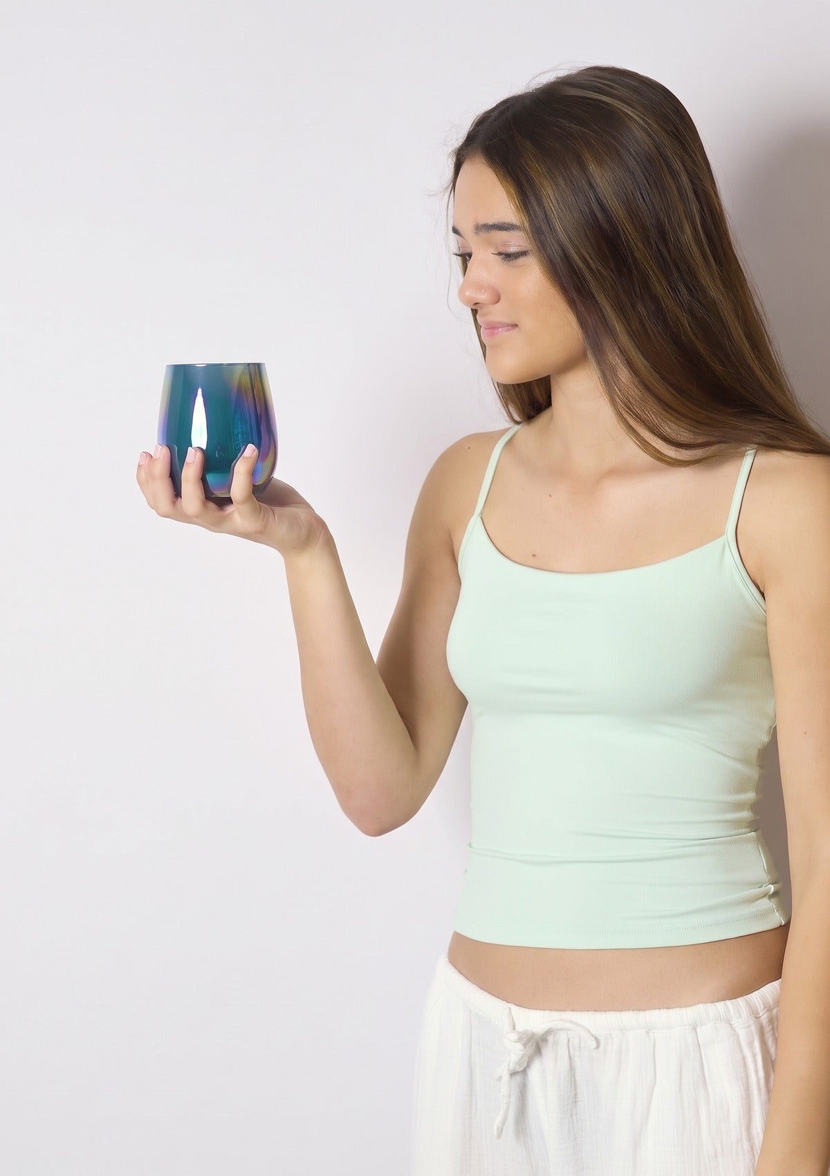 Model holding up the LUXA Deep Jade Luxe candle vessel