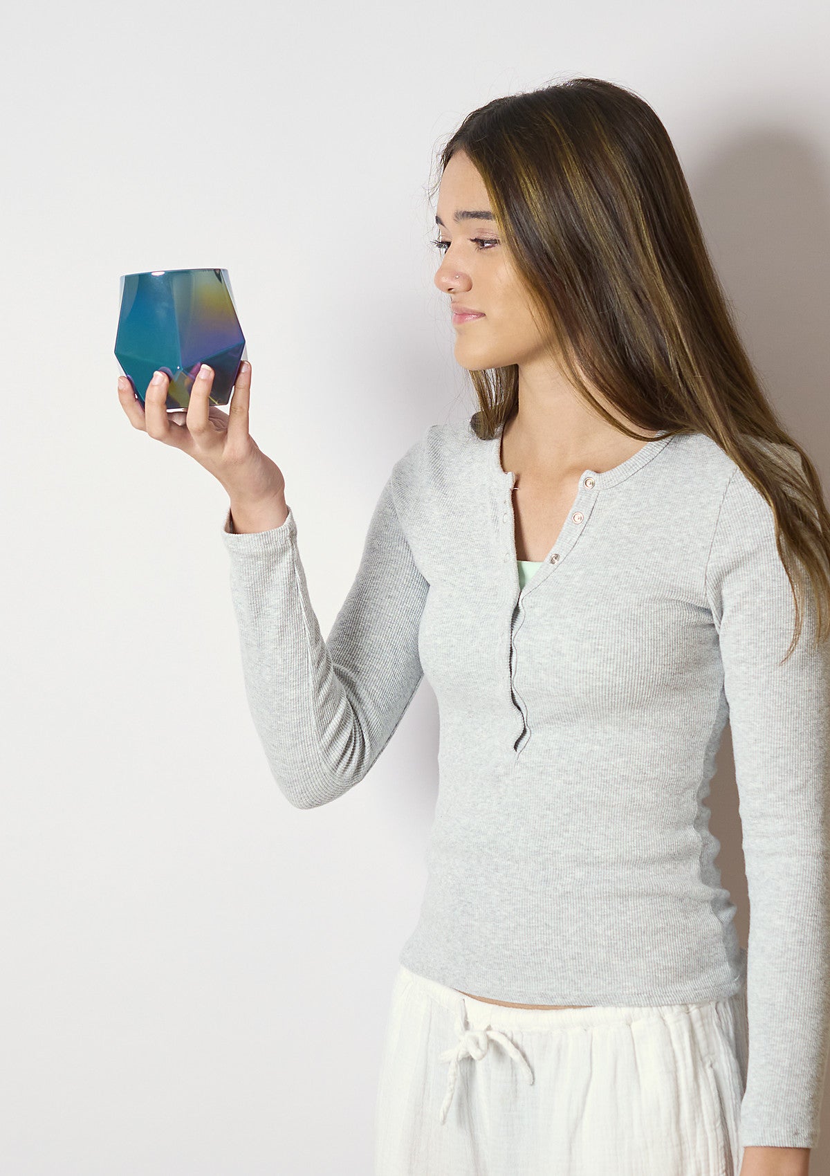 Model holding up the XEOS Deep Jade Luxe candle vessel