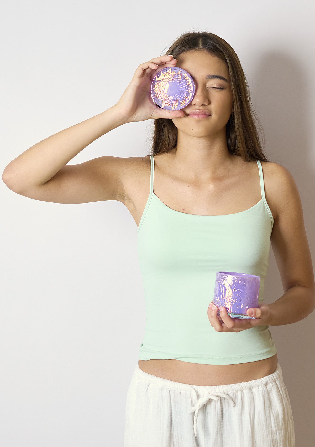 Model holding the ZIVA Lilac Luxe candle vessel