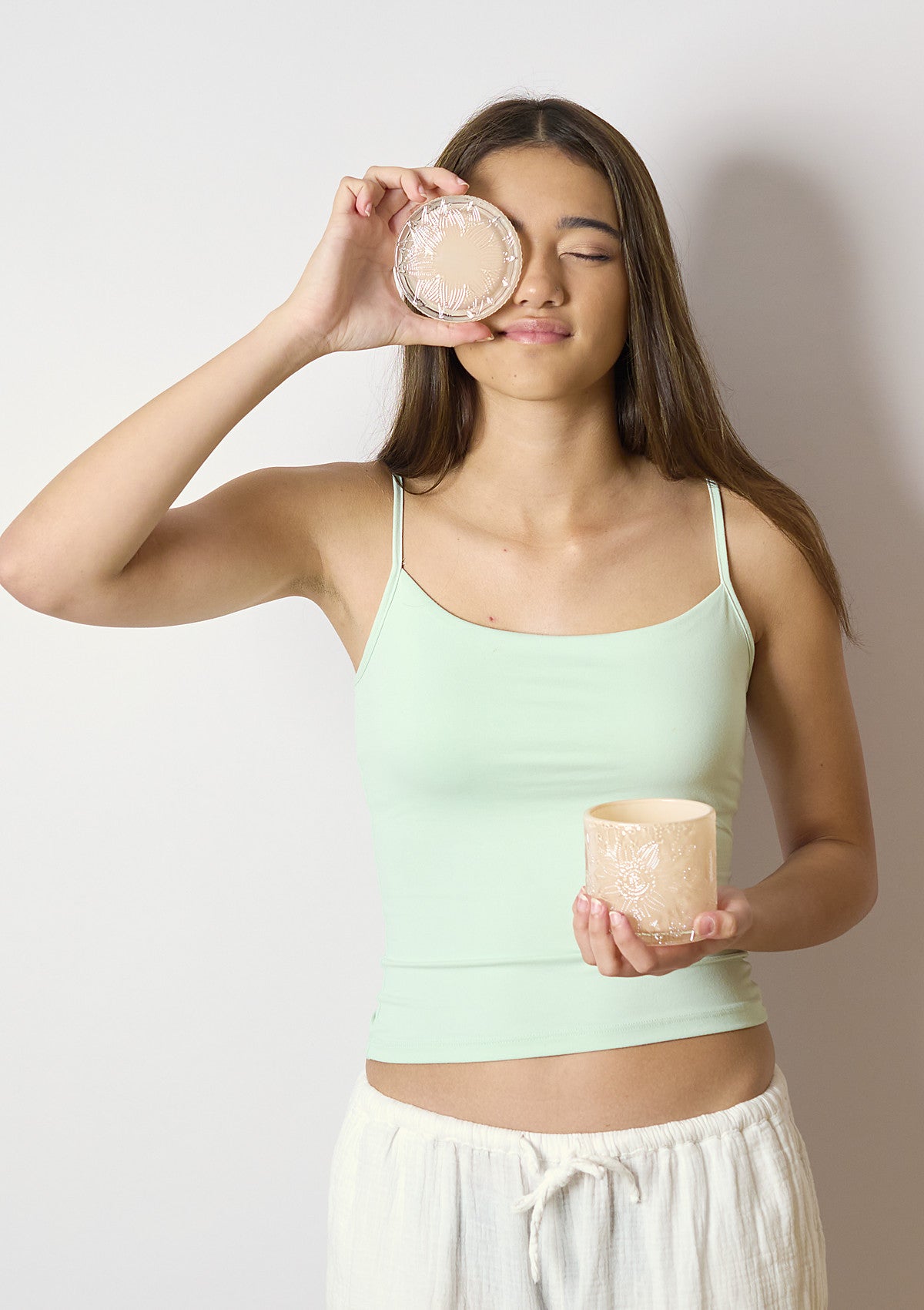 Model holding the ZIVA Shell Luxe candle vessel